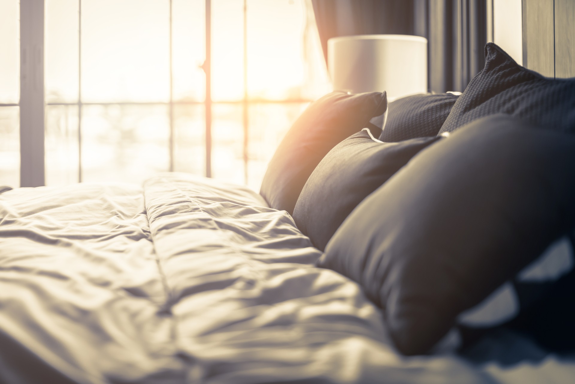 Bed maid-up with clean white pillows and bed sheets in beauty bedroom. Close-up. interior background