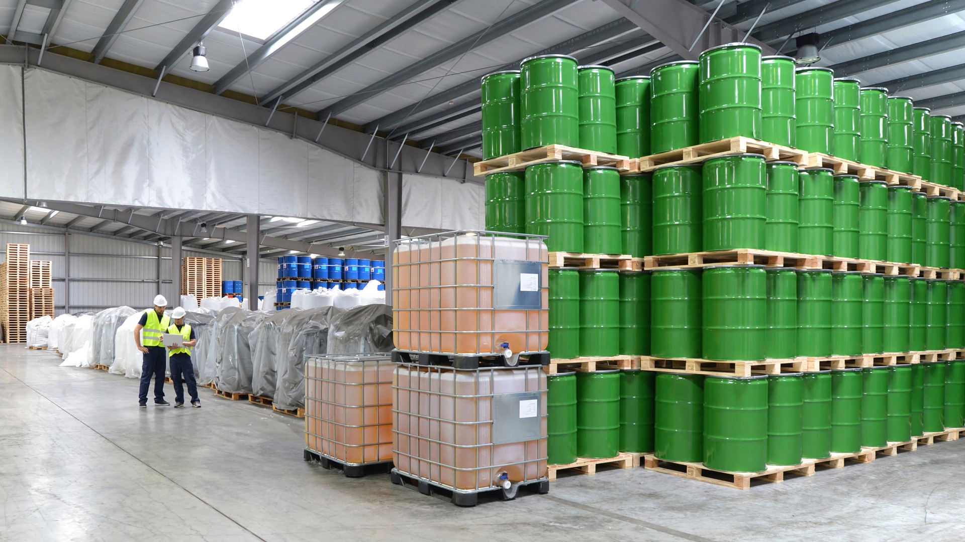 group of workers in the logistics industry work in a warehouse with chemicals